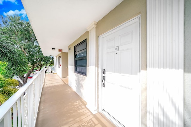 view of exterior entry featuring a balcony