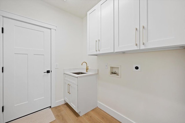 laundry area with sink, cabinets, electric dryer hookup, light hardwood / wood-style flooring, and hookup for a washing machine