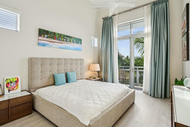 bedroom featuring ceiling fan, access to exterior, and light hardwood / wood-style flooring