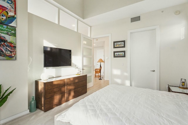 bedroom featuring a towering ceiling