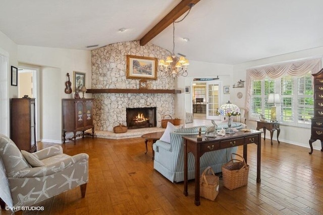 living room featuring hardwood / wood-style flooring, vaulted ceiling with beams, a fireplace, and an inviting chandelier