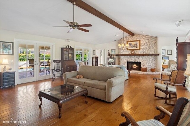 living room with ceiling fan, french doors, vaulted ceiling with beams, a stone fireplace, and hardwood / wood-style flooring