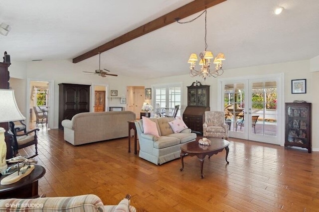 living room with french doors, ceiling fan with notable chandelier, lofted ceiling with beams, and wood-type flooring