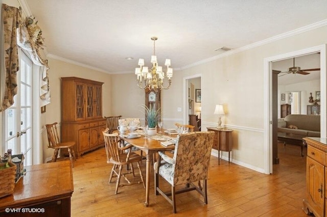 dining room with light hardwood / wood-style floors, ceiling fan with notable chandelier, and ornamental molding