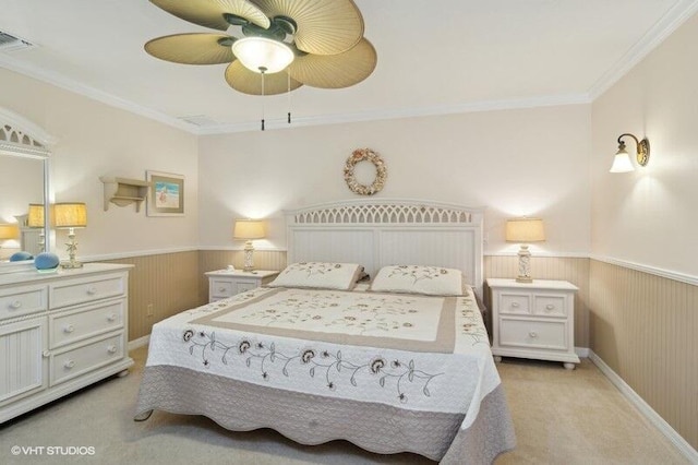 bedroom with light carpet, ceiling fan, and ornamental molding