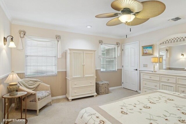 bedroom featuring ceiling fan, wood walls, light colored carpet, and crown molding