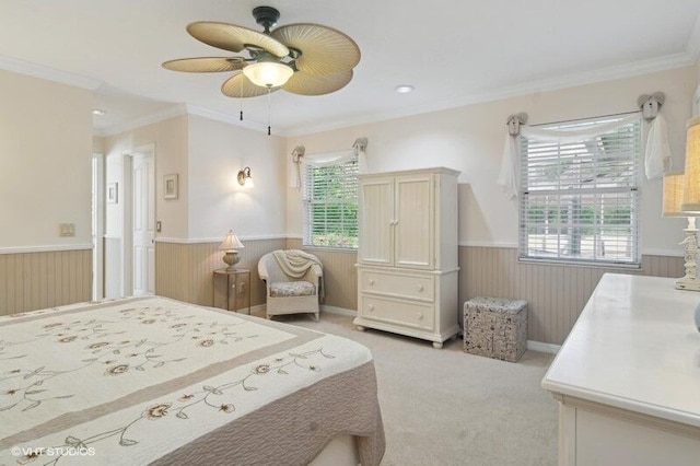 bedroom featuring ceiling fan, light colored carpet, and crown molding