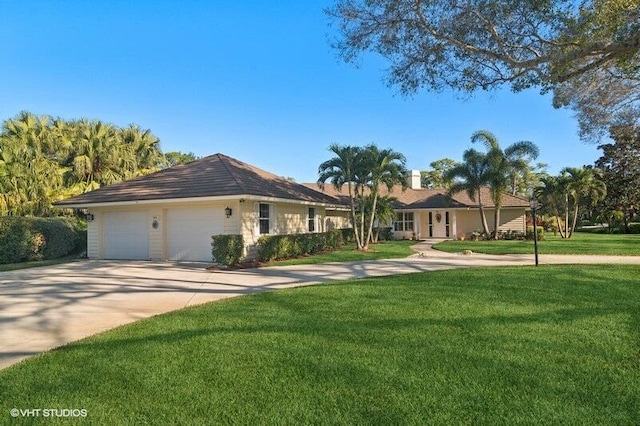 ranch-style home featuring a garage and a front lawn