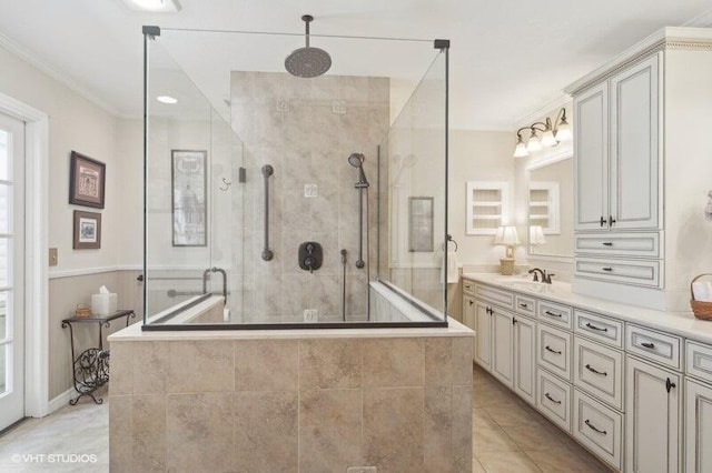 bathroom with tile patterned floors, crown molding, vanity, and walk in shower