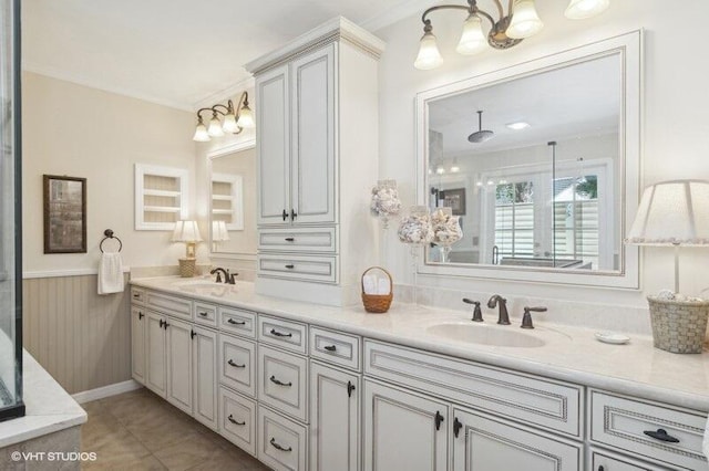 bathroom featuring tile patterned floors, vanity, and crown molding