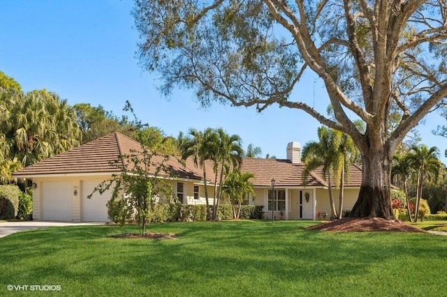 single story home featuring a front yard and a garage