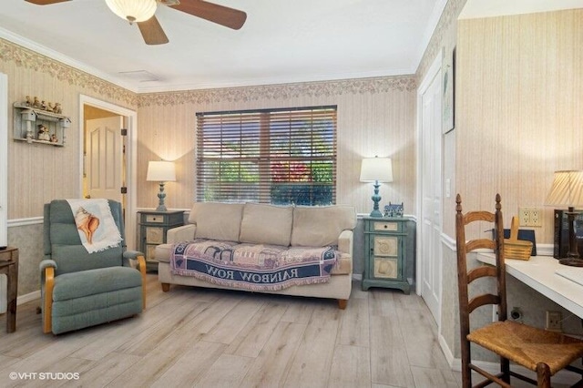 living room featuring ceiling fan, light wood-type flooring, and crown molding