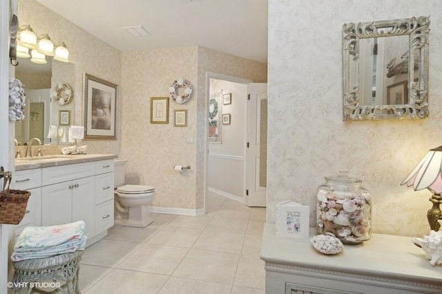 bathroom featuring tile patterned flooring, vanity, and toilet