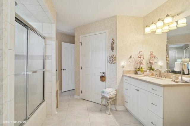 bathroom featuring tile patterned floors, vanity, and shower / bath combination with glass door