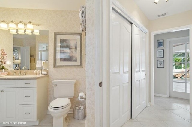 bathroom with tile patterned floors, vanity, and toilet