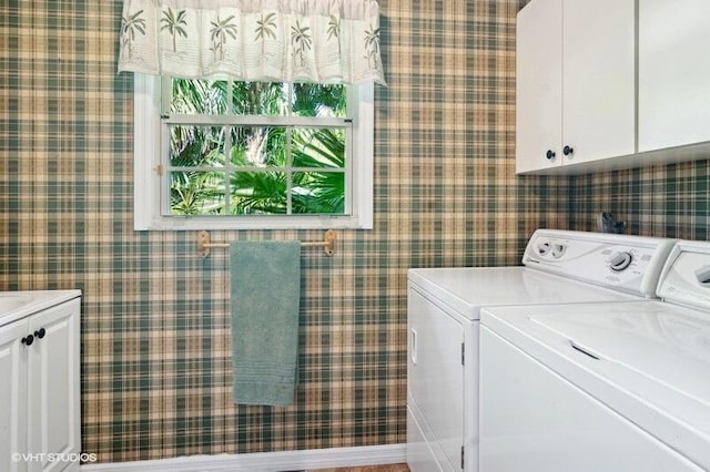 laundry room featuring cabinets and separate washer and dryer