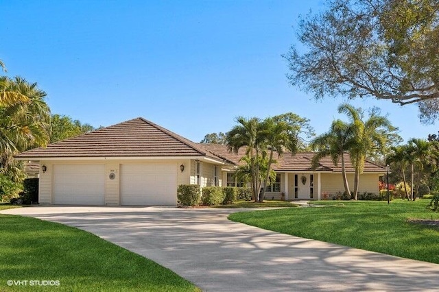 view of front of property with a front lawn and a garage