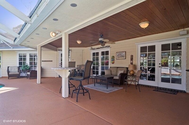 view of patio featuring outdoor lounge area, ceiling fan, and french doors