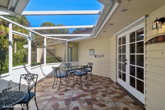 exterior space featuring french doors and glass enclosure