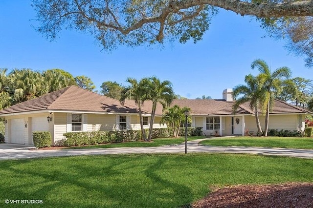 ranch-style home with a front yard and a garage