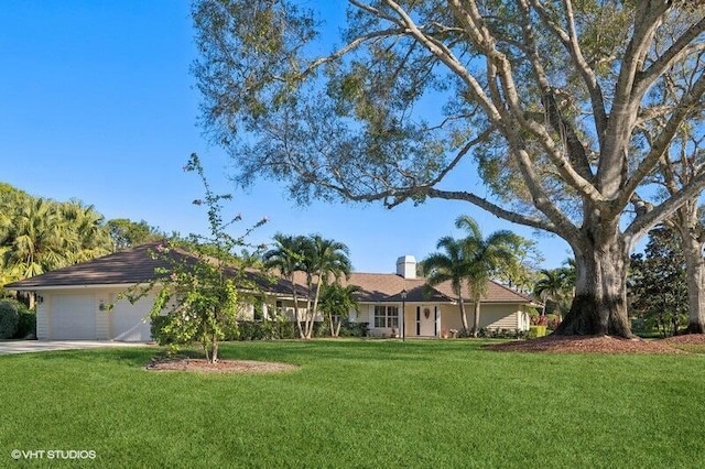 single story home with a garage and a front lawn