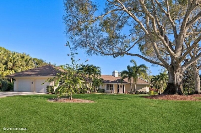 single story home featuring a front yard and a garage