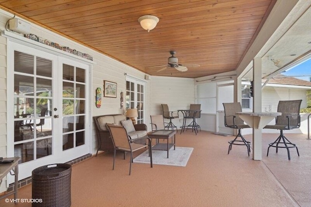 sunroom featuring ceiling fan, french doors, and wood ceiling