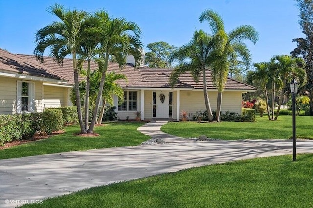 ranch-style home featuring a front yard