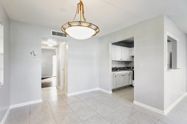 unfurnished dining area featuring light tile patterned floors