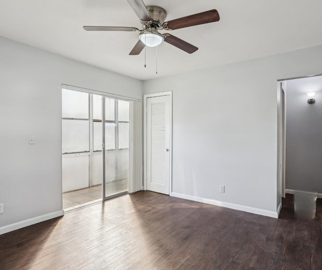 unfurnished bedroom with dark hardwood / wood-style flooring and ceiling fan