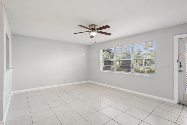 tiled empty room featuring ceiling fan