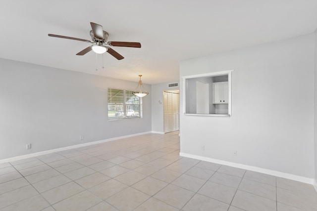 unfurnished room with ceiling fan and light tile patterned floors