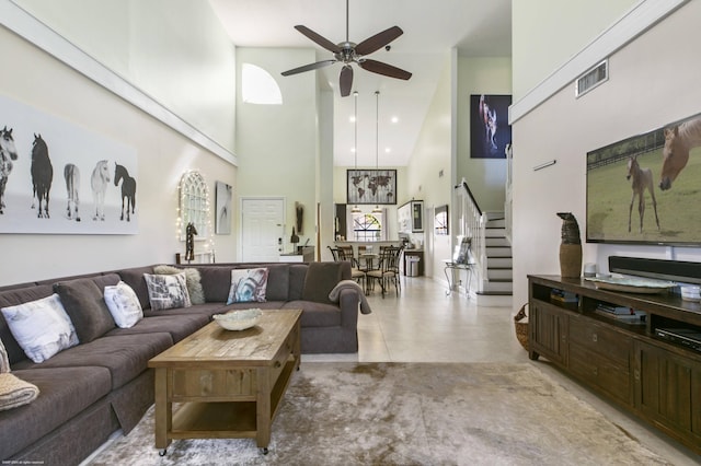 living room with a high ceiling and ceiling fan