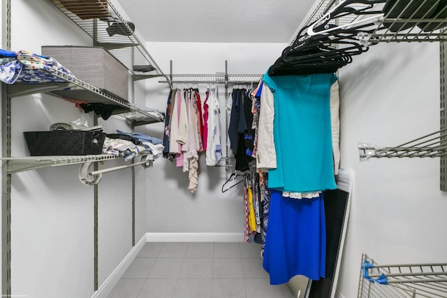 spacious closet with light tile patterned flooring