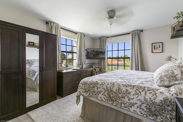 bedroom featuring ceiling fan and multiple windows