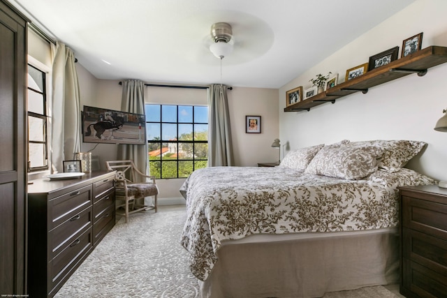 bedroom featuring ceiling fan and light colored carpet