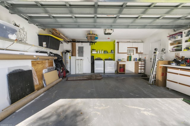 garage with a garage door opener, washer and dryer, electric panel, a workshop area, and water heater