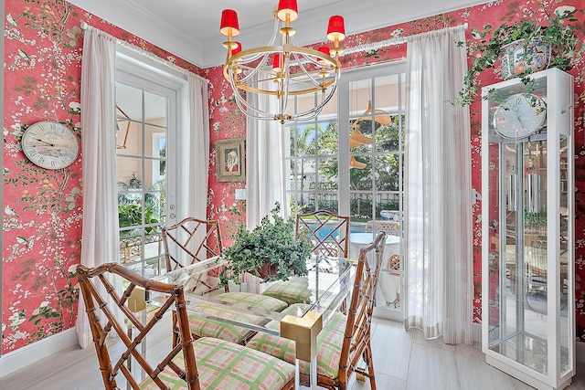 dining room with ornamental molding and a notable chandelier