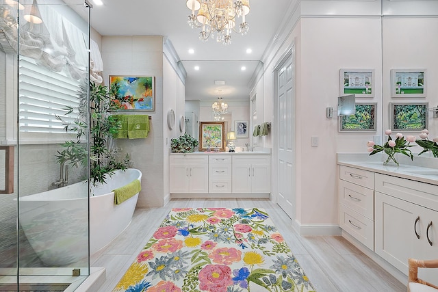 bathroom featuring plus walk in shower, vanity, a chandelier, and ornamental molding