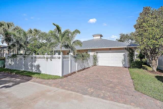 view of front of house with a garage and central AC