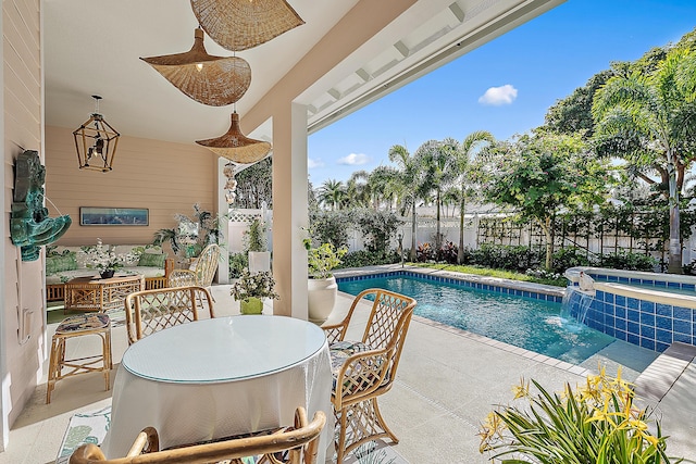 view of pool with pool water feature, an in ground hot tub, and a patio