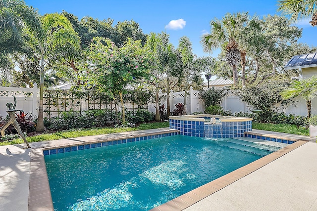 view of swimming pool with pool water feature and an in ground hot tub