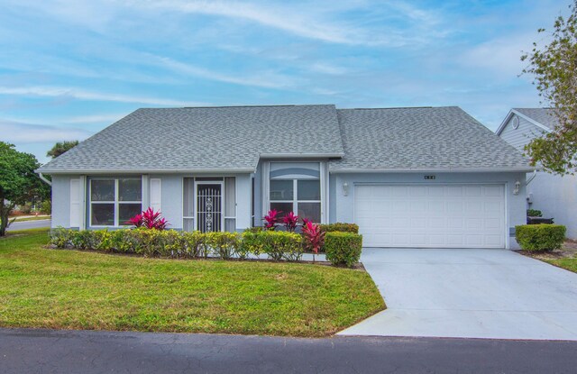 ranch-style home featuring a front yard and a garage