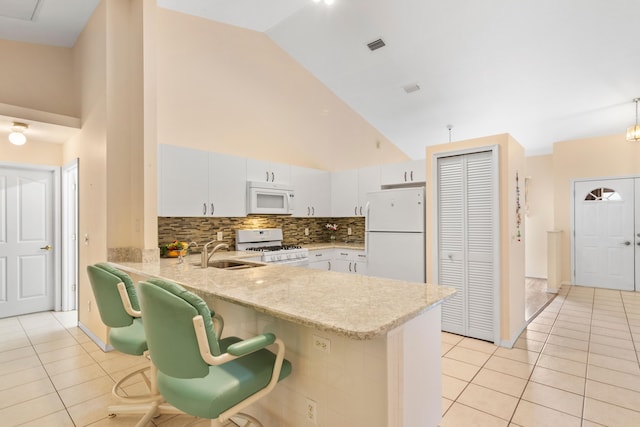 kitchen featuring sink, white appliances, white cabinetry, high vaulted ceiling, and light tile patterned floors