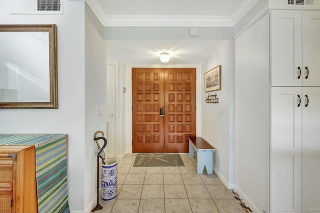 entrance foyer featuring light tile patterned flooring and crown molding