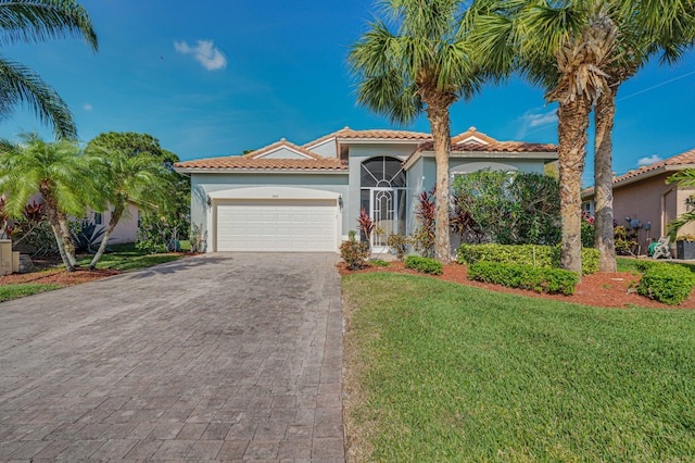 mediterranean / spanish-style home with a garage and a front yard