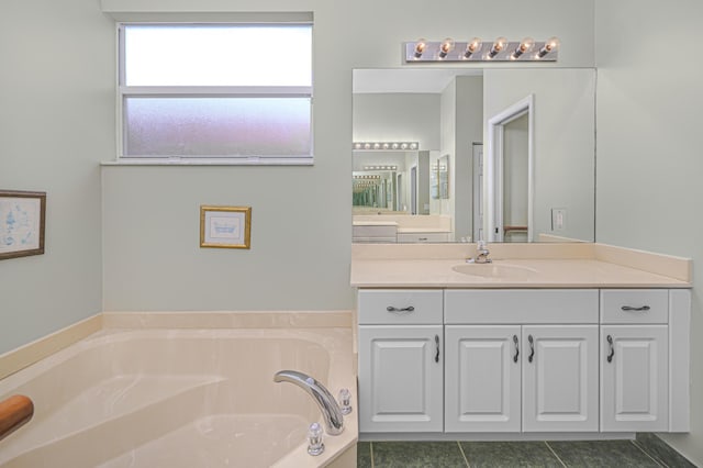 bathroom with vanity, tile patterned flooring, and a bathtub