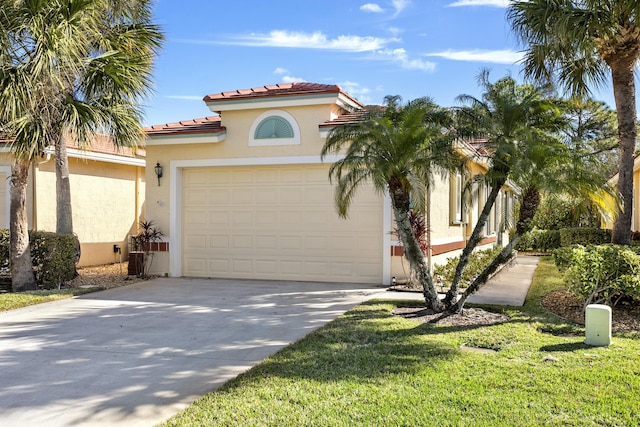 mediterranean / spanish home featuring a garage and a front yard