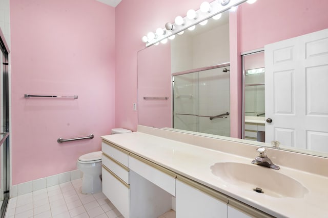 bathroom with vanity, tile patterned flooring, a shower stall, and toilet