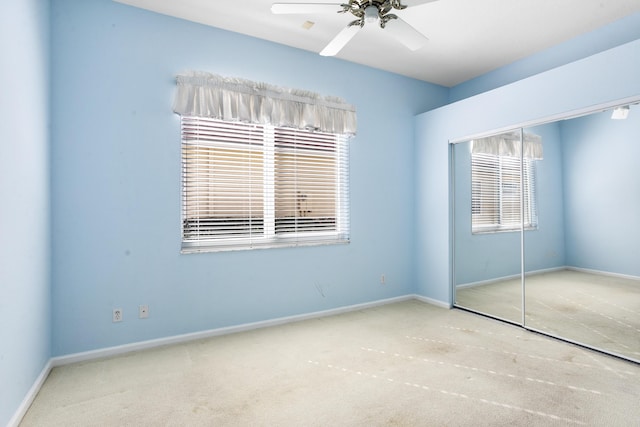 unfurnished bedroom with carpet floors, baseboards, and a closet